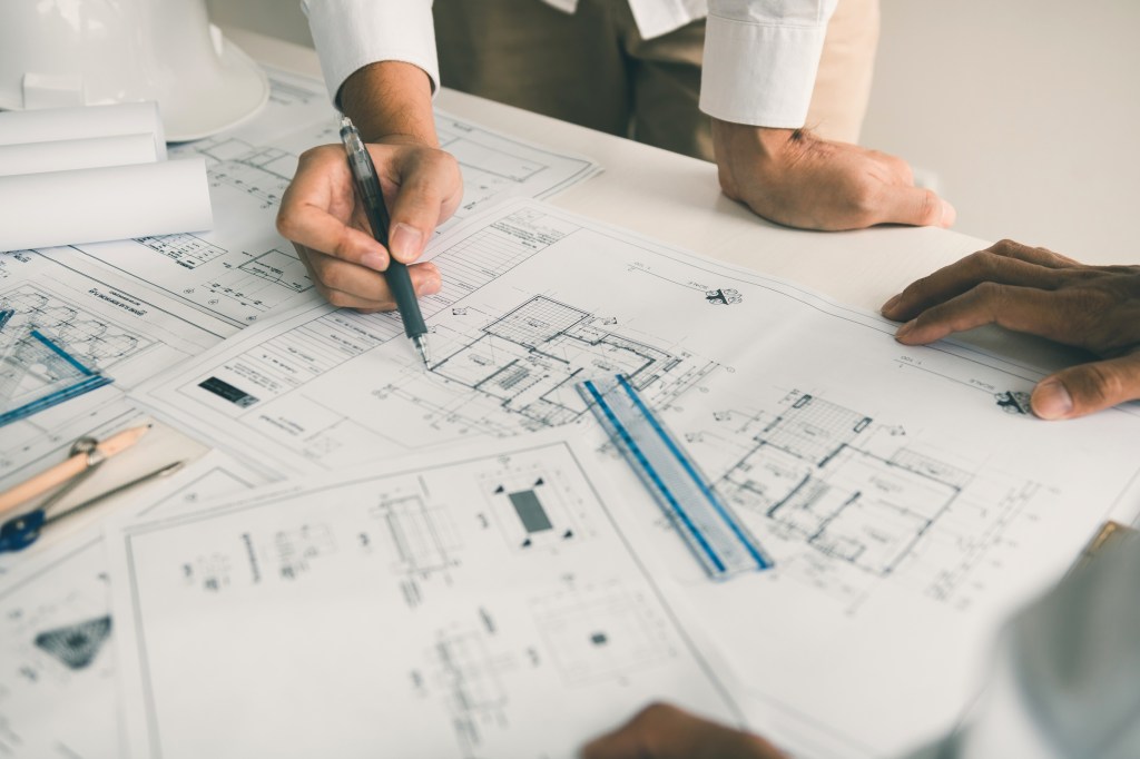 Architects reviewing house plans together at a table